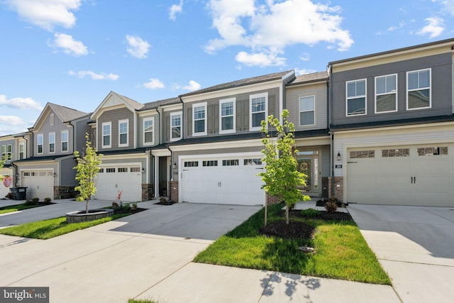 multi unit property featuring driveway, a residential view, stone siding, and a garage
