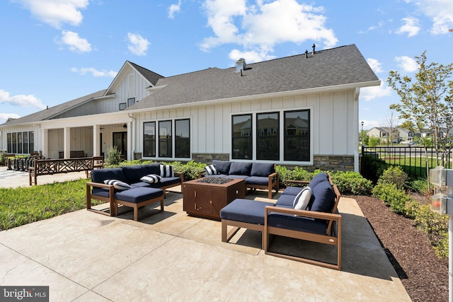 view of patio featuring an outdoor living space with a fire pit and fence