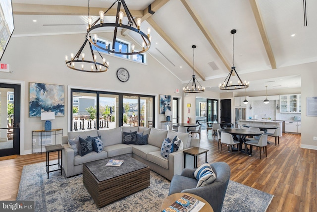 living room with high vaulted ceiling, beamed ceiling, wood finished floors, and a notable chandelier