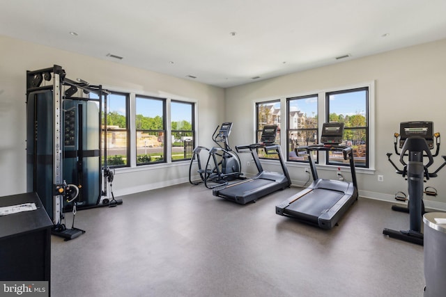 gym with baseboards and visible vents