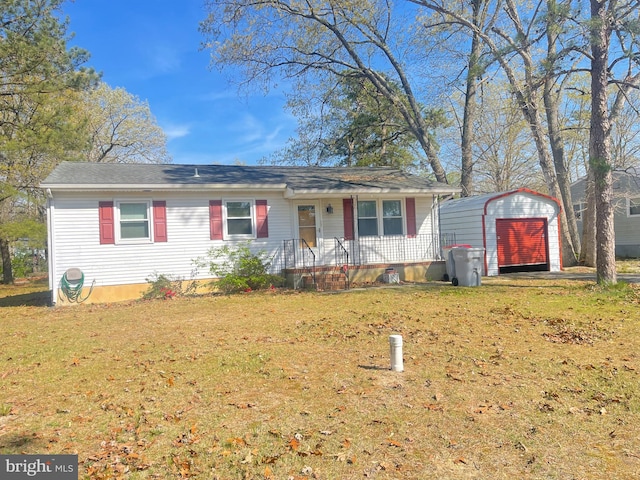ranch-style house featuring a storage shed, a front lawn, an outbuilding, and a detached garage