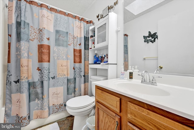 full bathroom with vanity, a textured ceiling, and toilet