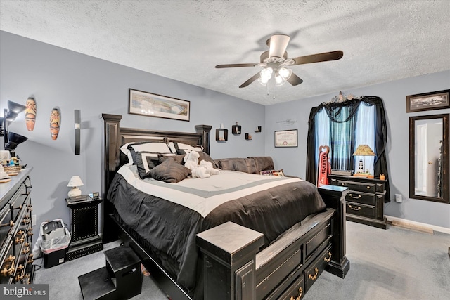 bedroom with carpet floors, a textured ceiling, ceiling fan, and baseboards