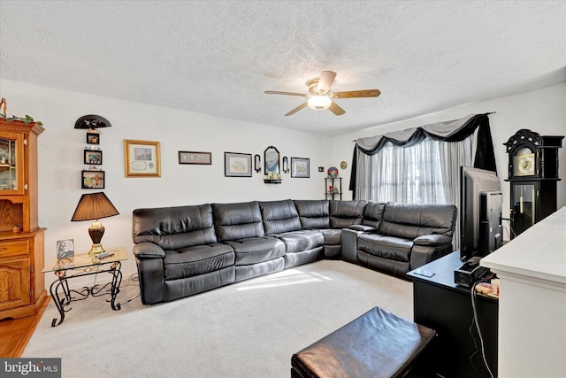 living room featuring carpet flooring, a textured ceiling, and ceiling fan
