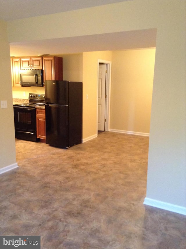 kitchen featuring baseboards and black appliances