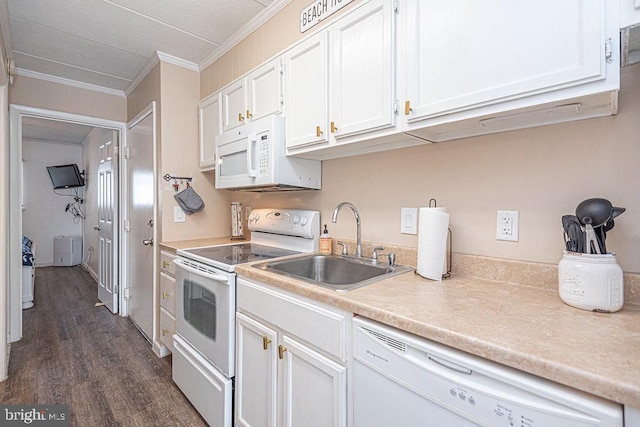 kitchen with dark wood-style flooring, light countertops, white cabinets, ornamental molding, and white appliances