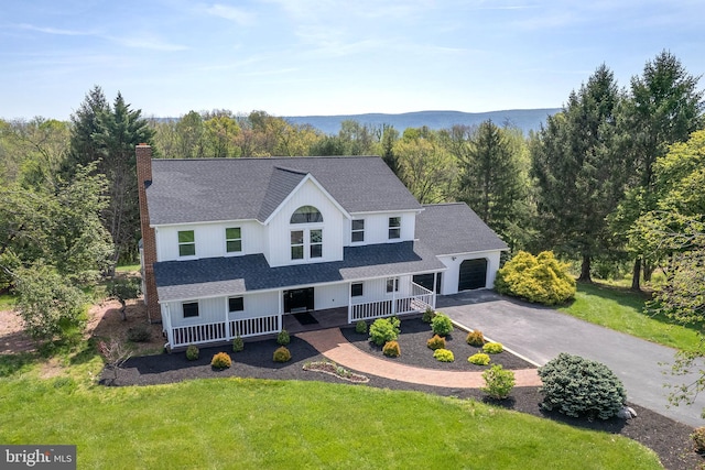 birds eye view of property with a view of trees