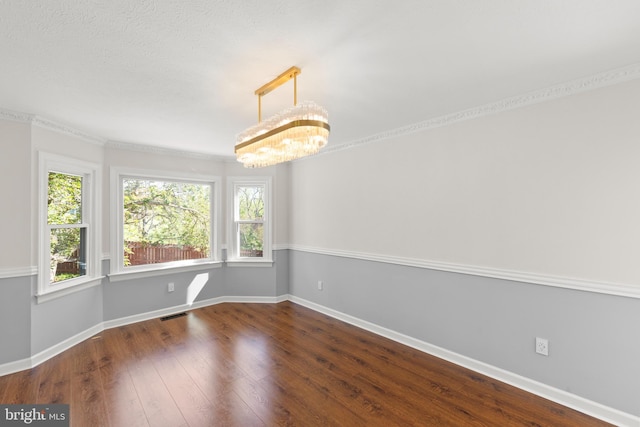 unfurnished dining area with baseboards, a notable chandelier, dark wood-style floors, and visible vents