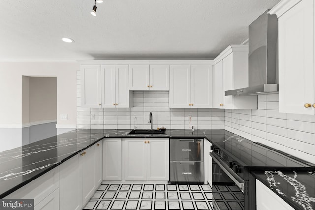 kitchen with tasteful backsplash, white cabinetry, a sink, electric stove, and wall chimney exhaust hood