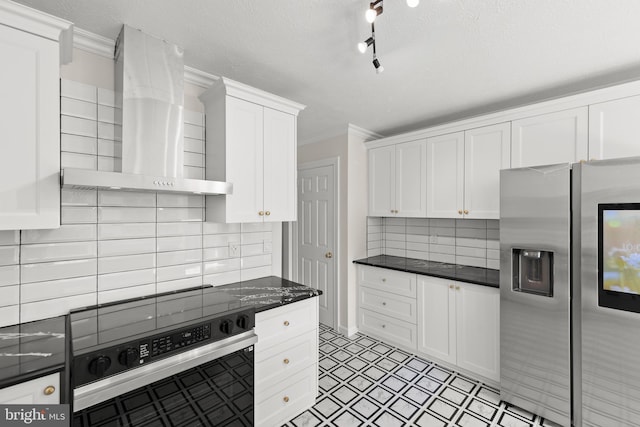 kitchen with range with electric cooktop, crown molding, dark countertops, stainless steel fridge with ice dispenser, and wall chimney exhaust hood