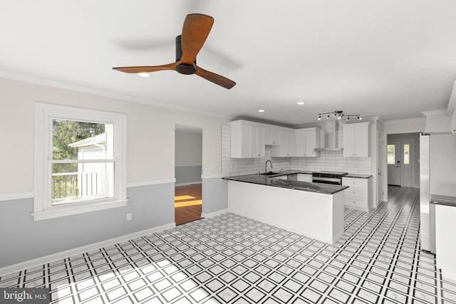 kitchen with white cabinets, stainless steel appliances, crown molding, and dark countertops