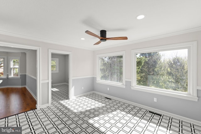 spare room featuring a ceiling fan, visible vents, crown molding, baseboards, and recessed lighting