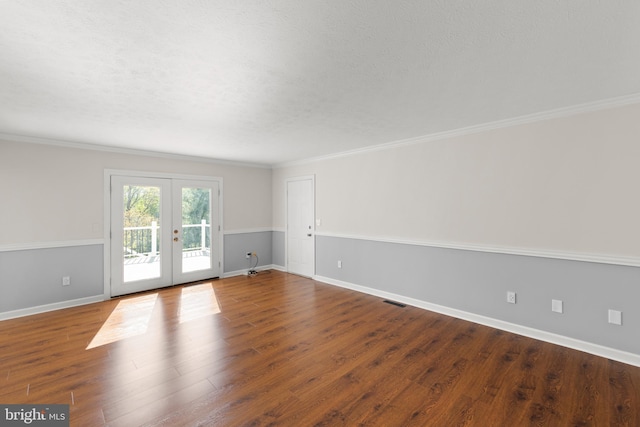 empty room with crown molding, baseboards, french doors, and wood finished floors