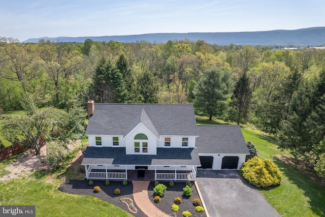 birds eye view of property with a view of trees
