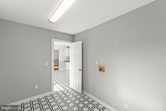 interior space featuring laundry area, hookup for a washing machine, light floors, and baseboards
