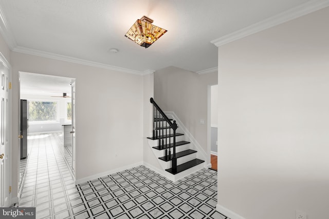 stairs featuring crown molding, tile patterned floors, ceiling fan, and baseboards