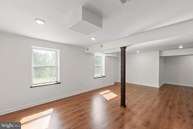 basement featuring recessed lighting, baseboards, visible vents, and wood finished floors