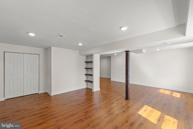 finished basement with baseboards, recessed lighting, wood finished floors, and visible vents