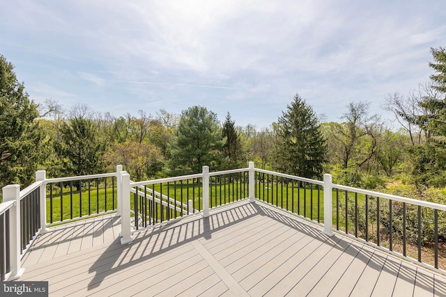 wooden terrace with a lawn