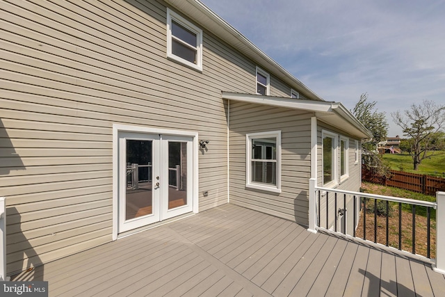 deck featuring fence and french doors