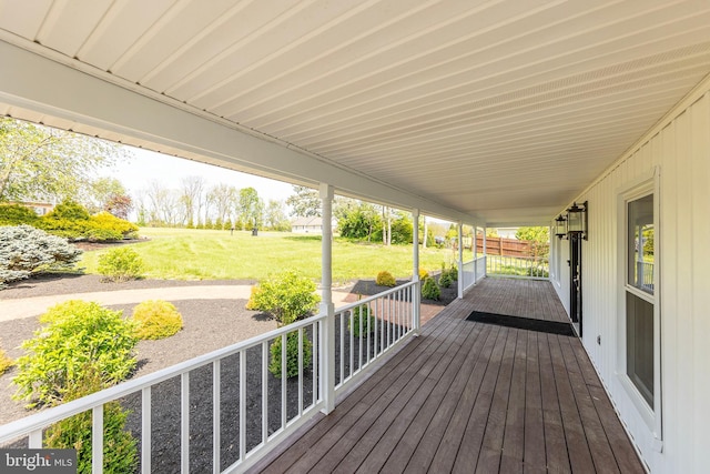 deck with a porch and a yard