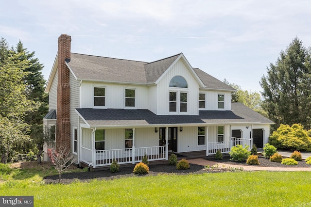 view of front of home with a shingled roof, a chimney, a porch, and a garage