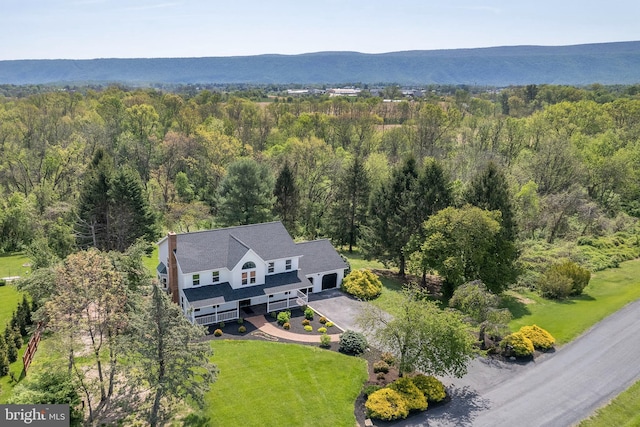birds eye view of property with a forest view