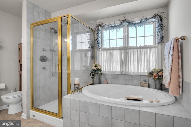 full bathroom with a shower stall, toilet, and a garden tub