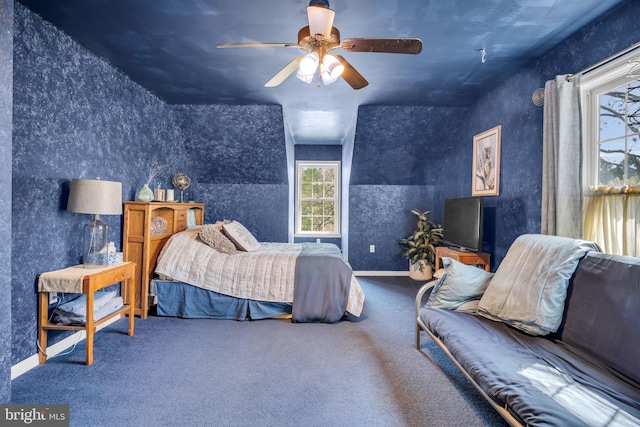 carpeted bedroom featuring wallpapered walls and ceiling fan
