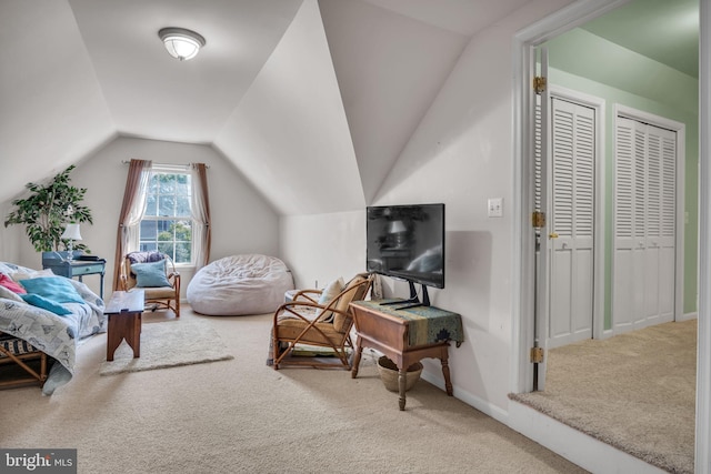 interior space featuring baseboards, carpet, and lofted ceiling
