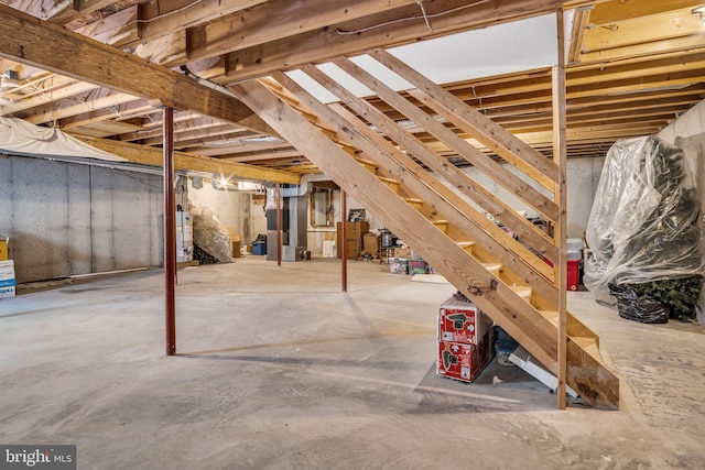 unfinished basement with heating unit and gas water heater