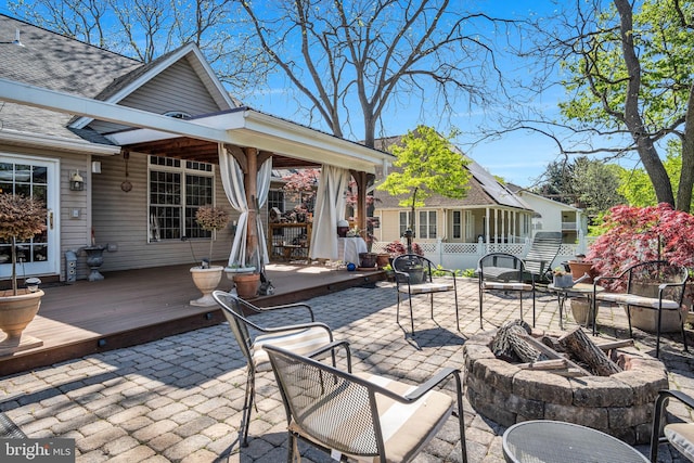 view of patio / terrace featuring a wooden deck and a fire pit