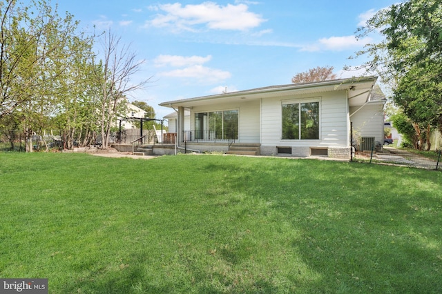 back of property with a lawn