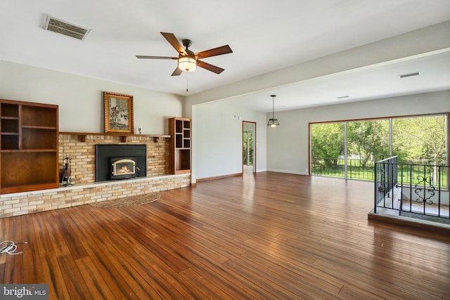 unfurnished living room featuring visible vents, ceiling fan, and wood finished floors