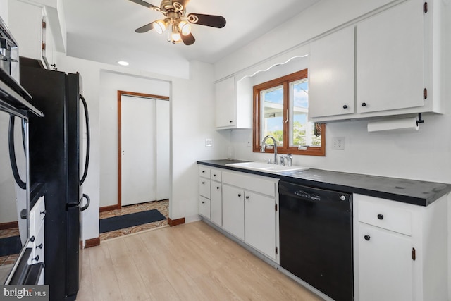 kitchen with a ceiling fan, dark countertops, a sink, white cabinets, and black appliances