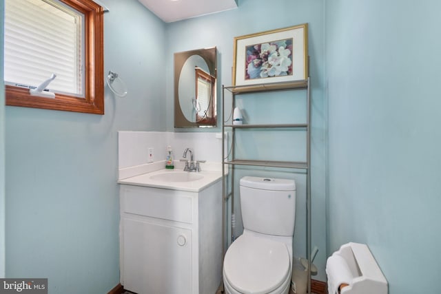 half bath featuring toilet and vanity