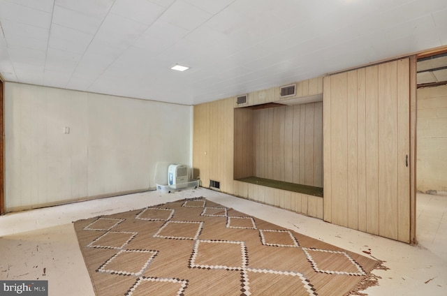 interior space with visible vents and wood walls