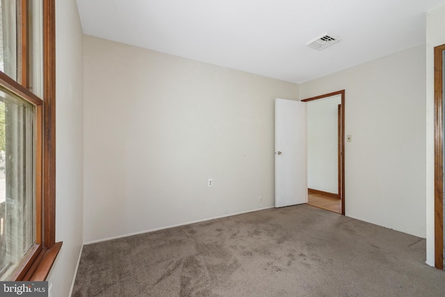 unfurnished bedroom with carpet flooring and visible vents