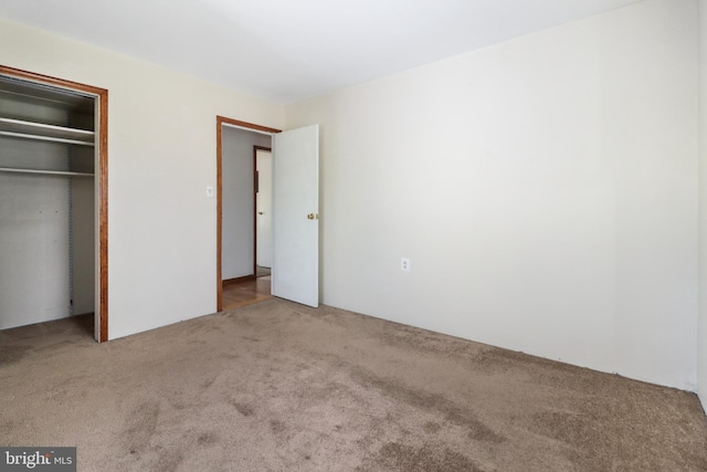 unfurnished bedroom with carpet floors and a closet