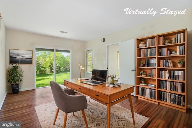 home office featuring baseboards, wood finished floors, and visible vents
