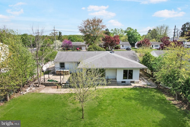 rear view of house with a yard