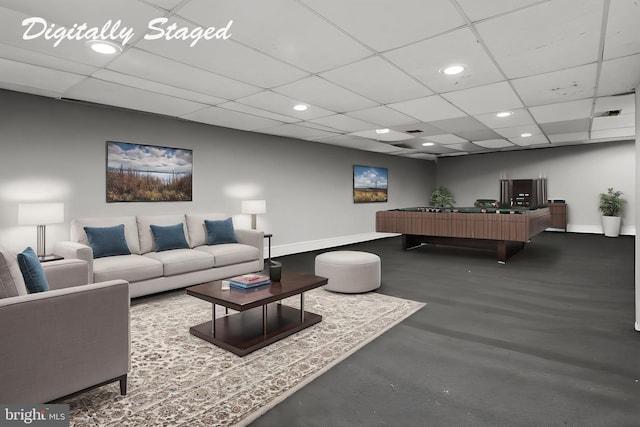 living area featuring recessed lighting, baseboards, a drop ceiling, and finished concrete flooring