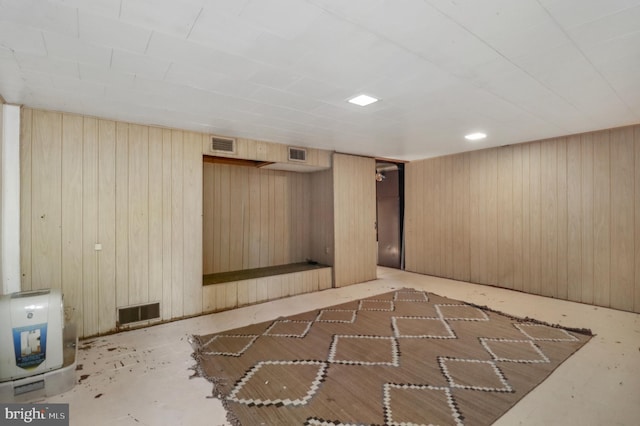 finished below grade area with visible vents and wooden walls