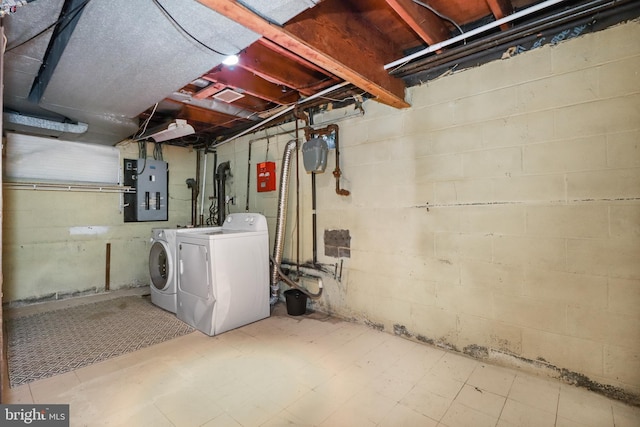 unfinished below grade area with washer and clothes dryer and electric panel