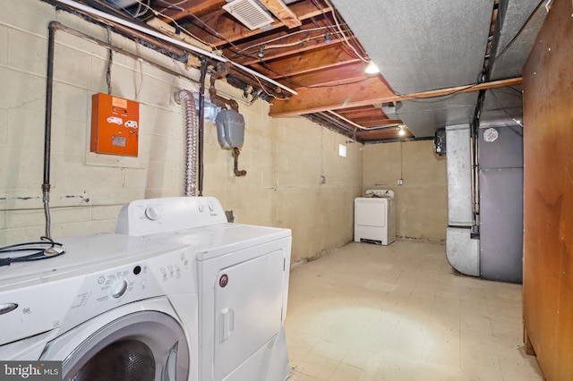 laundry area featuring laundry area, visible vents, tile patterned floors, heating unit, and washer and dryer