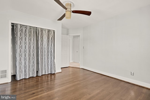 unfurnished bedroom with ceiling fan, baseboards, visible vents, and wood finished floors