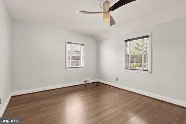 spare room featuring visible vents, baseboards, ceiling fan, and wood finished floors