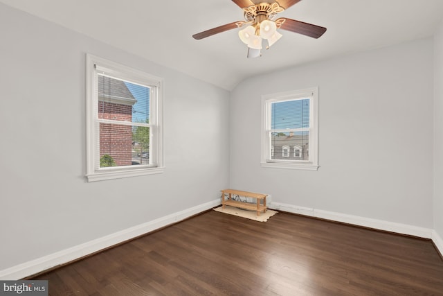 empty room featuring baseboards, plenty of natural light, wood finished floors, and ceiling fan