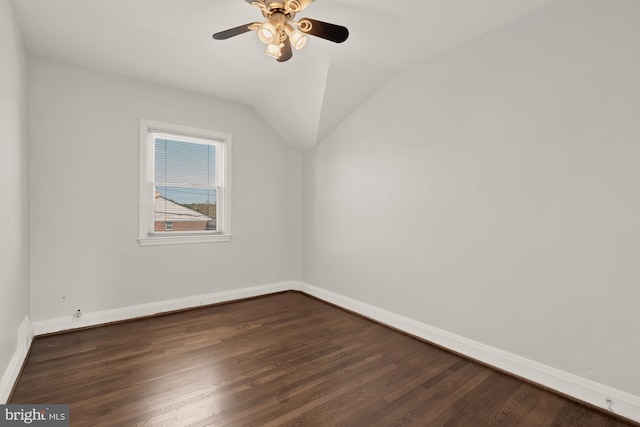 bonus room with a ceiling fan, baseboards, vaulted ceiling, and dark wood-style floors