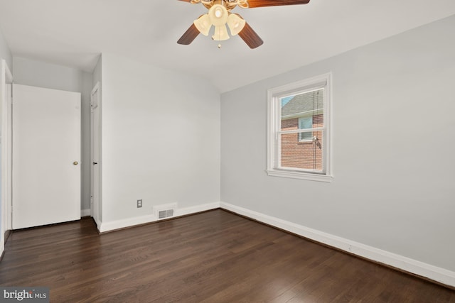 unfurnished bedroom featuring a ceiling fan, baseboards, visible vents, and dark wood finished floors